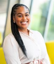 Headshot image of Delisa Williams, who is wearing a white blouse and a golden earring