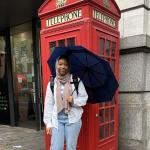 Haneefah Jones stands in front of a telephone booth in London