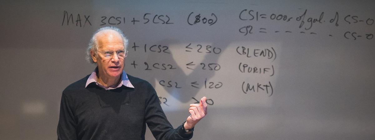 A professor teaching at the front of the classroom