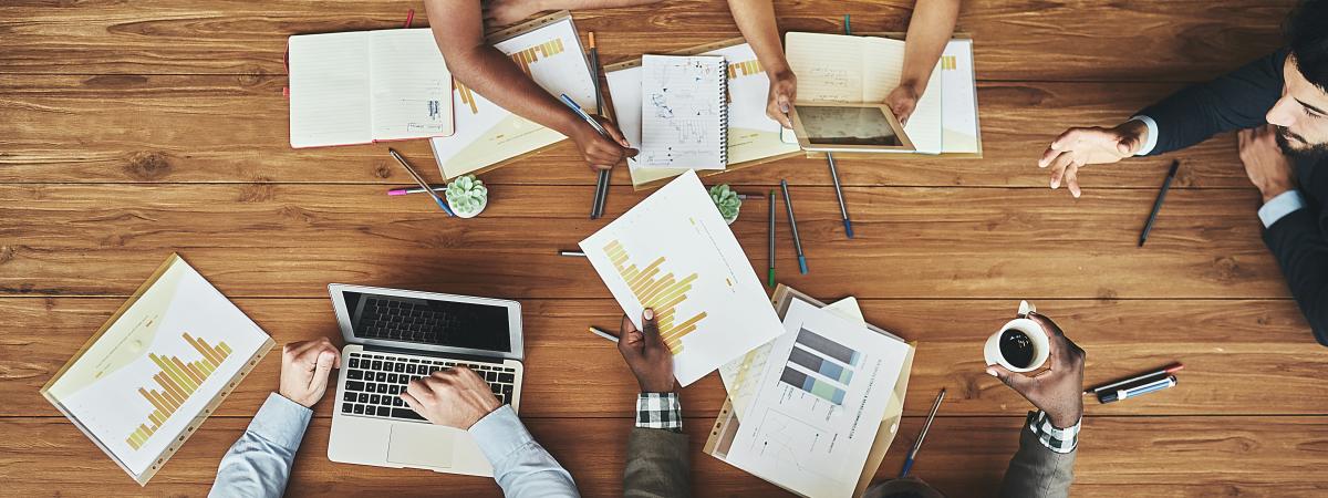High angle shot of a team of businesspeople meeting around the boardroom table in the office