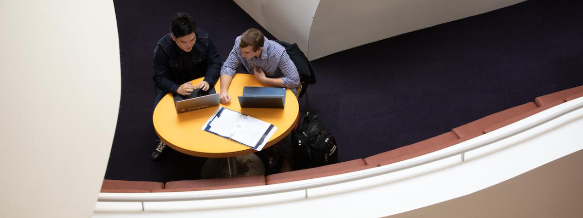 View looking down on two students seated at a table inside the Peter B. Lewis Building