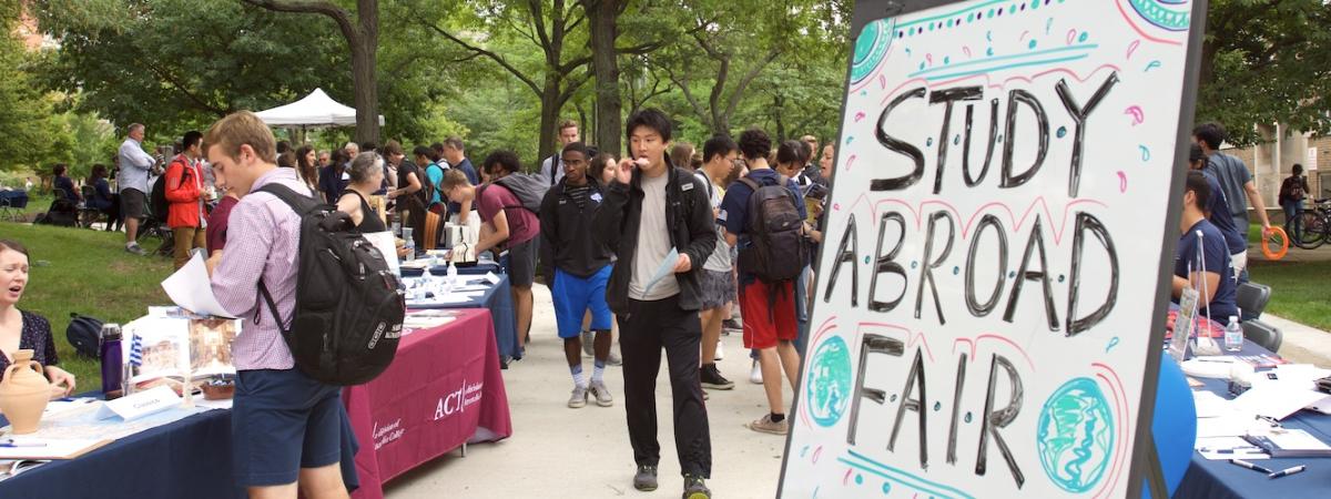 Students mingle at an outdoor study abroad fair