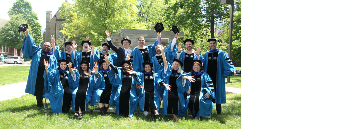 DBA grads throwing their caps in the air