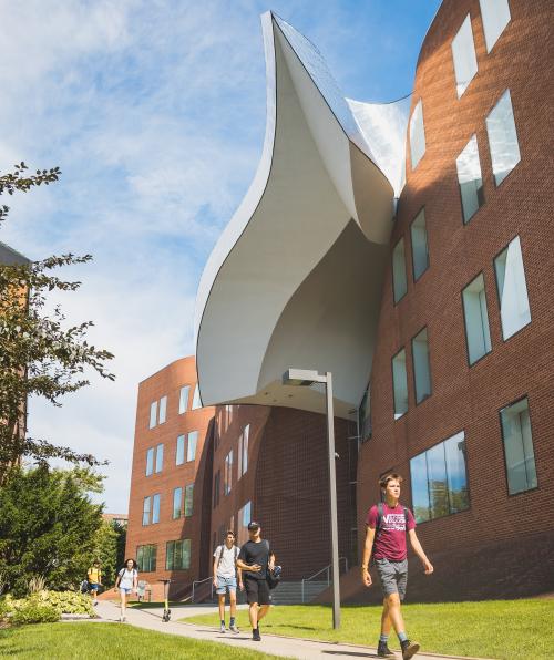 Students walk outside the Peter B Lewis Building on a sunny day