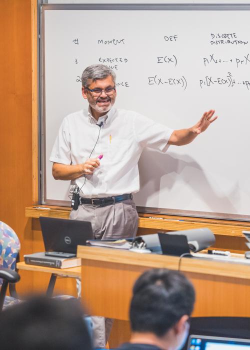 A faculty member using a whiteboard while teaching