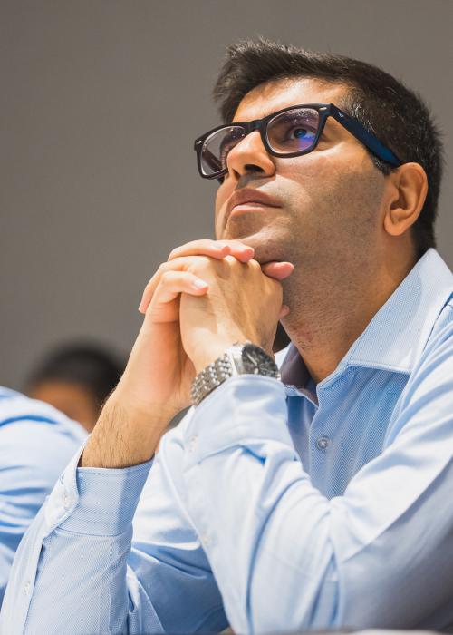 Close up shot of a student peering up intently during a lecture