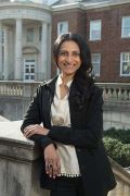 Headshot image of Radhika Zaveri, a woman wearing a black cardigan and white blouse