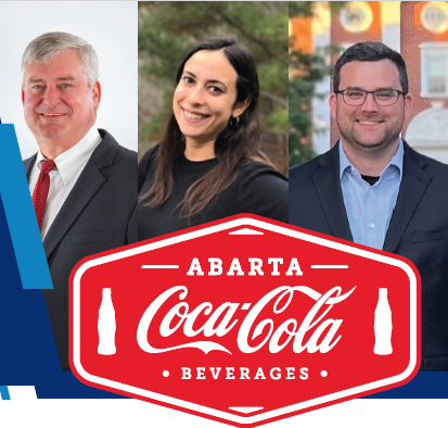 ABARTA Coca Cola; people standing behind logo