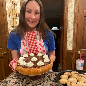 Photo of Milana Sacco holding a cake