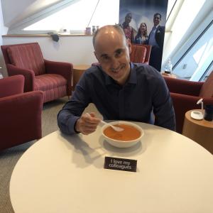 Dean Andrew Medvedev sitting at a table eating soup