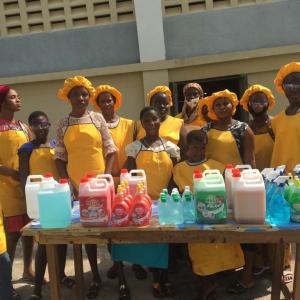 An image of a group of girls standing behind a table.