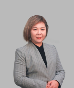 Yicong (Fiona) Wang smiles in a grey suit against a grey background