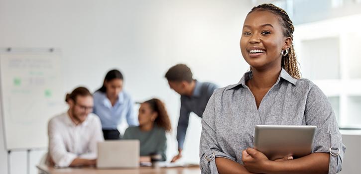 young professional woman smiling with people in background