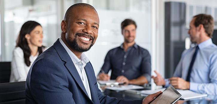 business man professional smiling with people in background