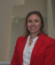 Professional headshot image of Celeste Blau wearing a red blazer