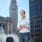 Picture of Michael Goldberg next to a fountain, city buildings in background