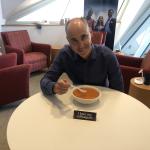 Dean Andrew Medvedev sitting at a table eating soup