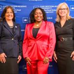 Laura Leopardi, Yvette Simpson, and Laura Guilliam pose for a photo at the Women's Leadership Luncheon