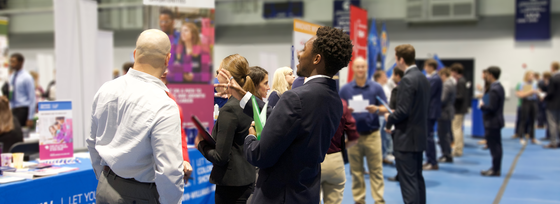 Photo of students and company representatives mingling at a Career Fair in the Tinkham Veale University Center