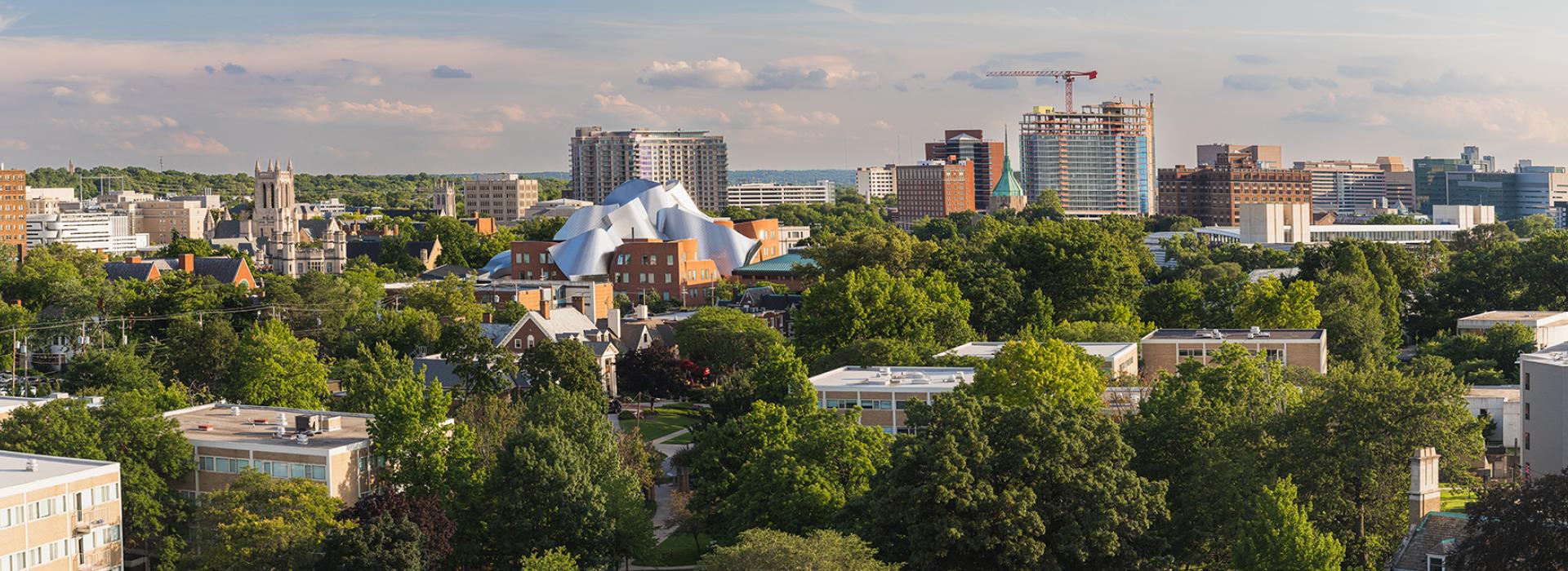 Photo of a panoramic view of the cwru campus with skyscrapers in the background