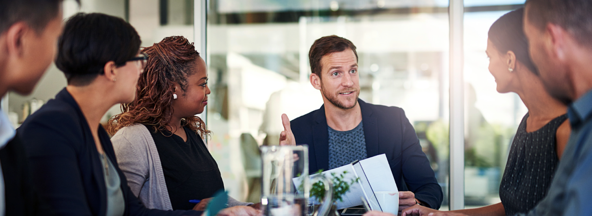 A stock photo of professionals in a presentational meeting