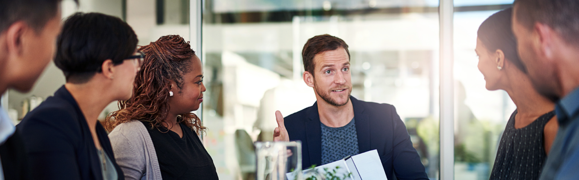 A stock photo of professionals in a presentational meeting
