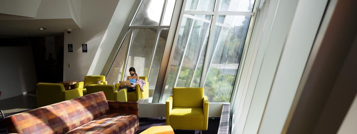 Sun beaming in windows onto multi-colored furniture in the Peter B. Lewis Building