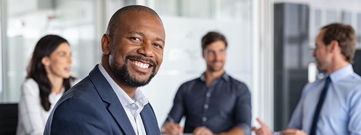 business man professional smiling with people in background