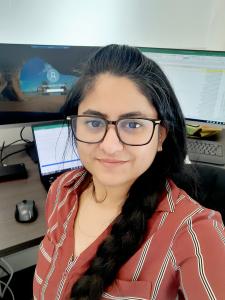 Paridhi Maheshwari smiles at her desk at Great Lakes Cheese