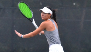 Chloe Ku gets ready to hit a tennis ball during a match.