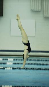 Elena Igac dives into the water during a swim meet.