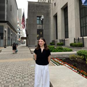 Brooke Hatthorn smiles outside of the St. Louis Fed Building