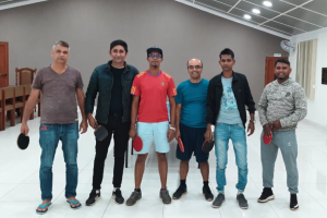 Rakesh Niraj takes a group picture with people who he played ping-pong with in Mauritius