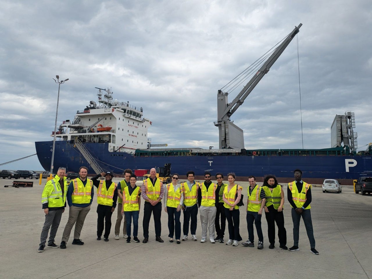 Students standing in front of a freight ship