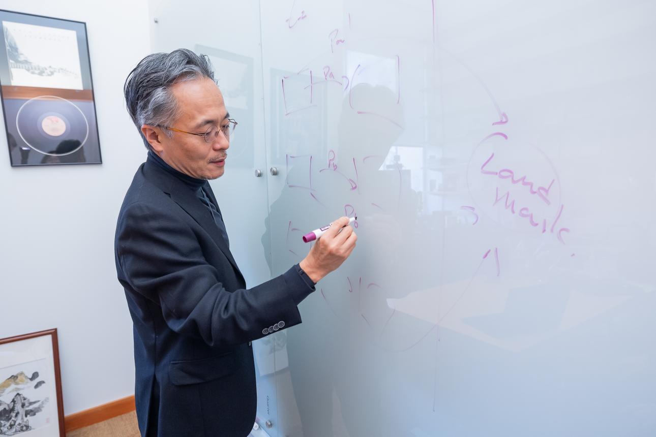 Professor writing on a white board