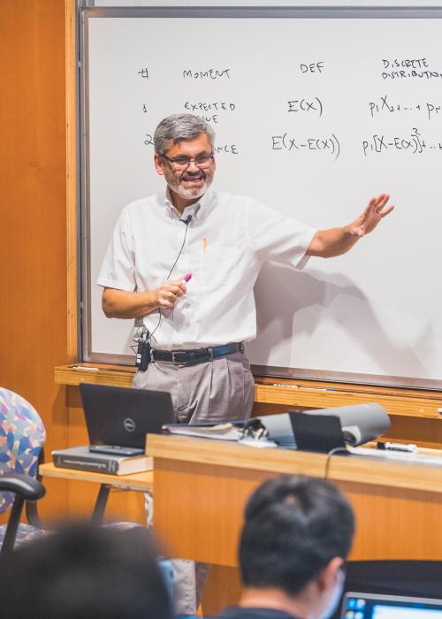 A faculty member using a whiteboard while teaching