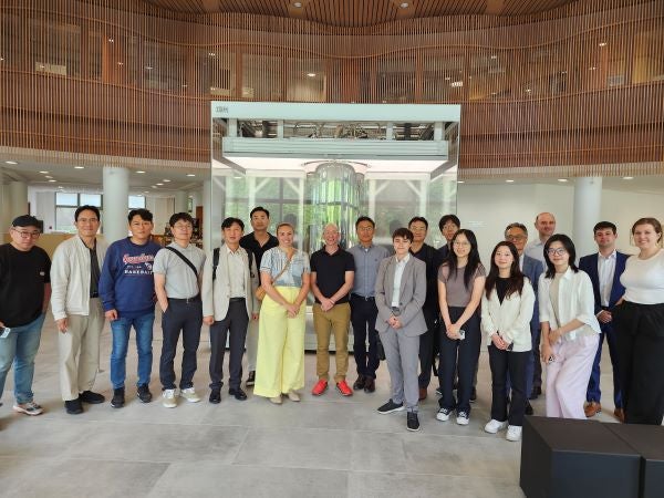 Wide-angle photograph of a group of Weatherhead students meeting with visiting executives from LG