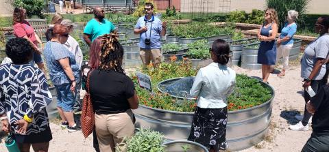 Brian Gray and Juan Jeffrey sharing information with fellow CWRU employees at the Garden@Case community garden site on campus