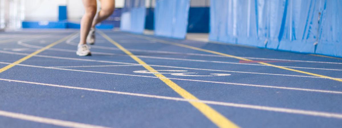 A person running on the Case Western Reserve University Veale Center track